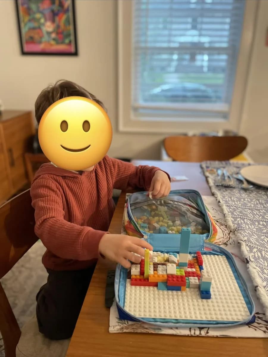 Customer photo of a child playing with Brick Hero Case at a table
