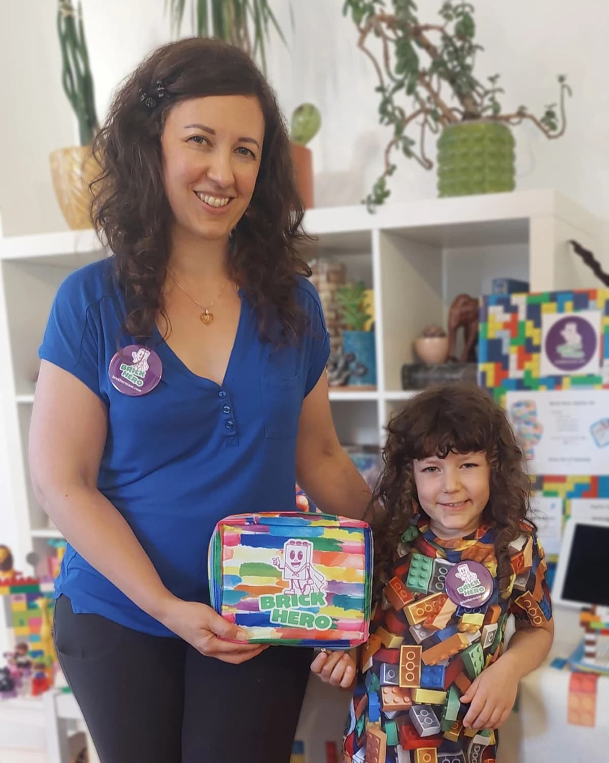 Brick Hero founder and child holding a colorful Brick Hero case